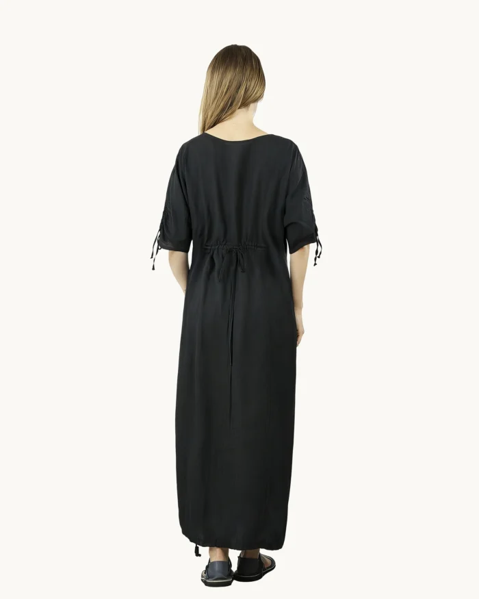 Czarna maxi lniana sukienka oversize, ozdobiona ręcznie malowanymi dmuchawcami, uszyta przez Naturalnie Podlasek, widok z tyłu